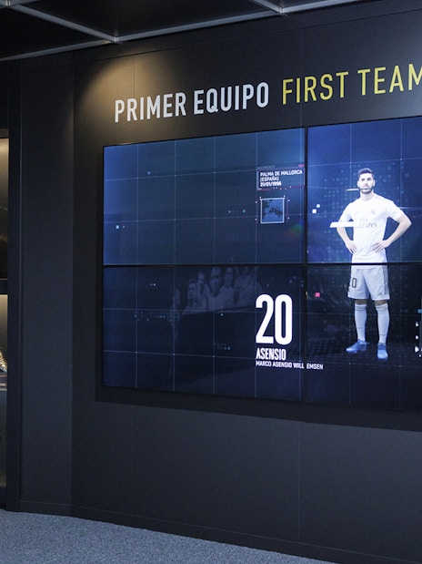 Trophy display at Santiago Bernabéu Stadium museum, featuring football awards and memorabilia.
