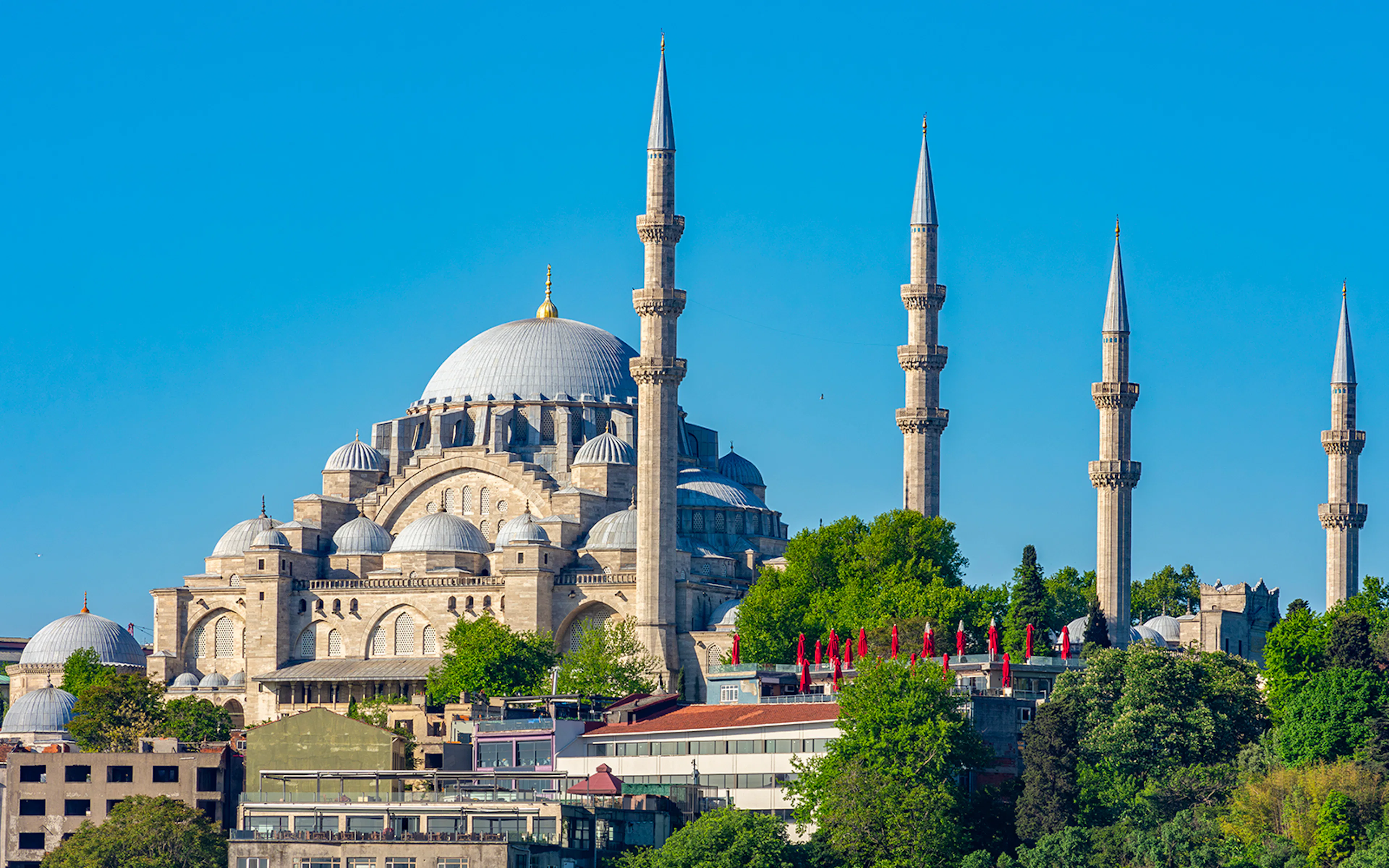 Suleymaniye Mosque with minarets in Istanbul, Turkey, surrounded by greenery.