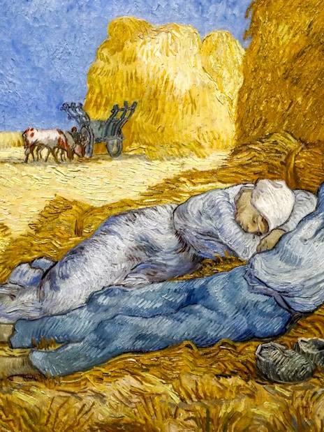 Two figures resting on haystacks in a field, with a cart and oxen in the background, from Van Gogh's work.