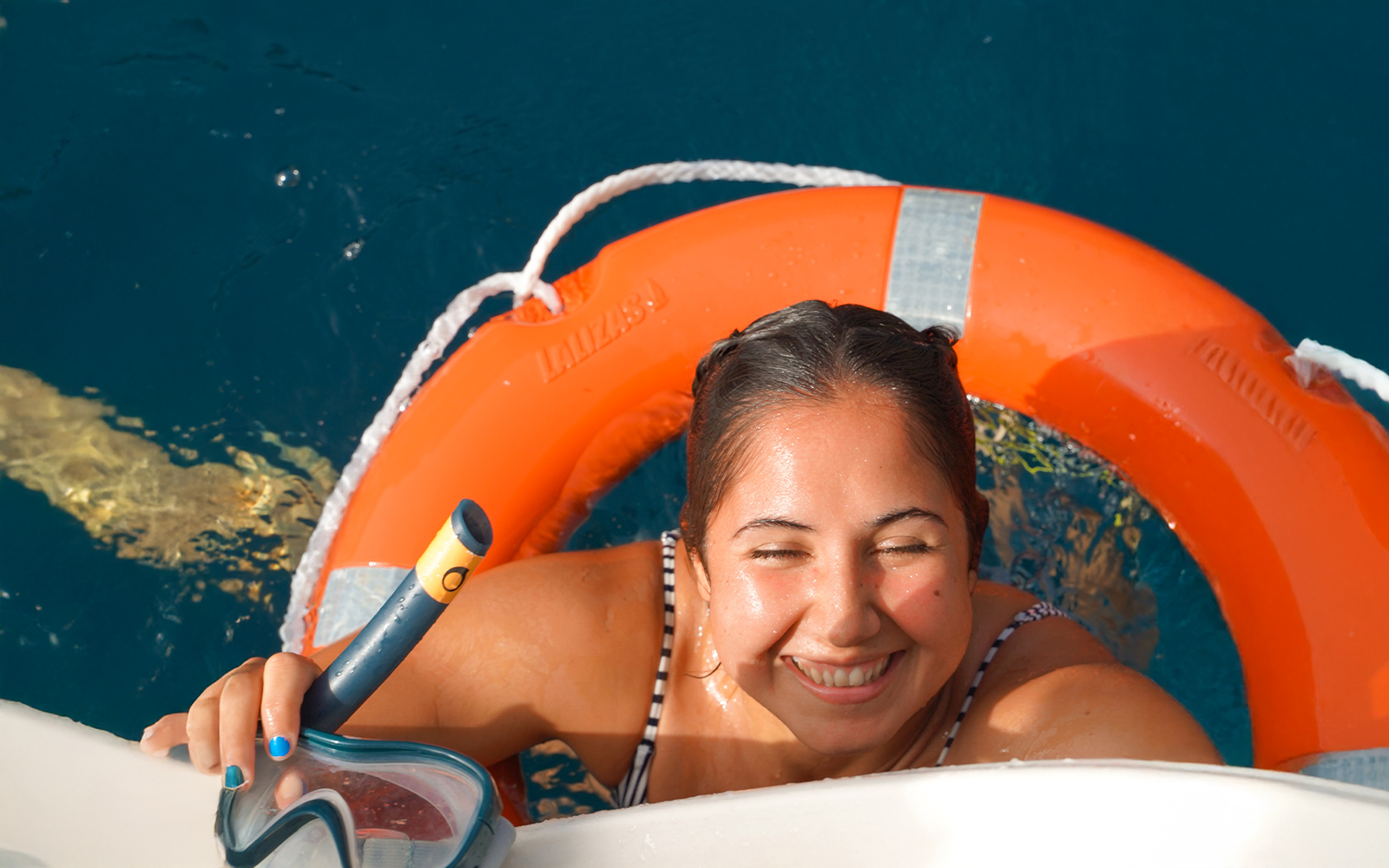 Tourist smiling after snorkeling on a private sailboat in Tenerife.