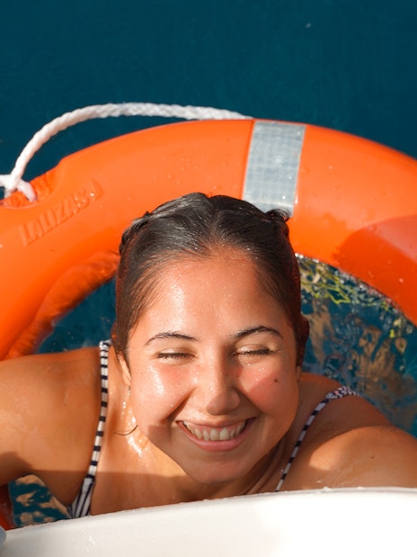 Tourist smiling after snorkeling on a private sailboat in Tenerife.