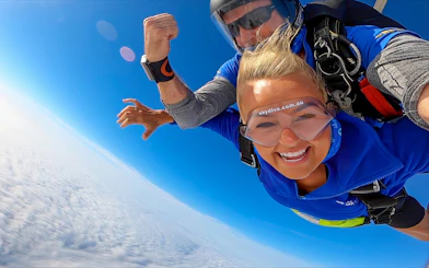 Tandem skydiving over Newcastle, Australia with woman and instructor.