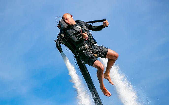 Jetpack rider soaring over water at The Palm Jumeirah.