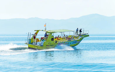 Boat with tourists on Alcudia's coast during a 3-hour caves and snorkel trip.