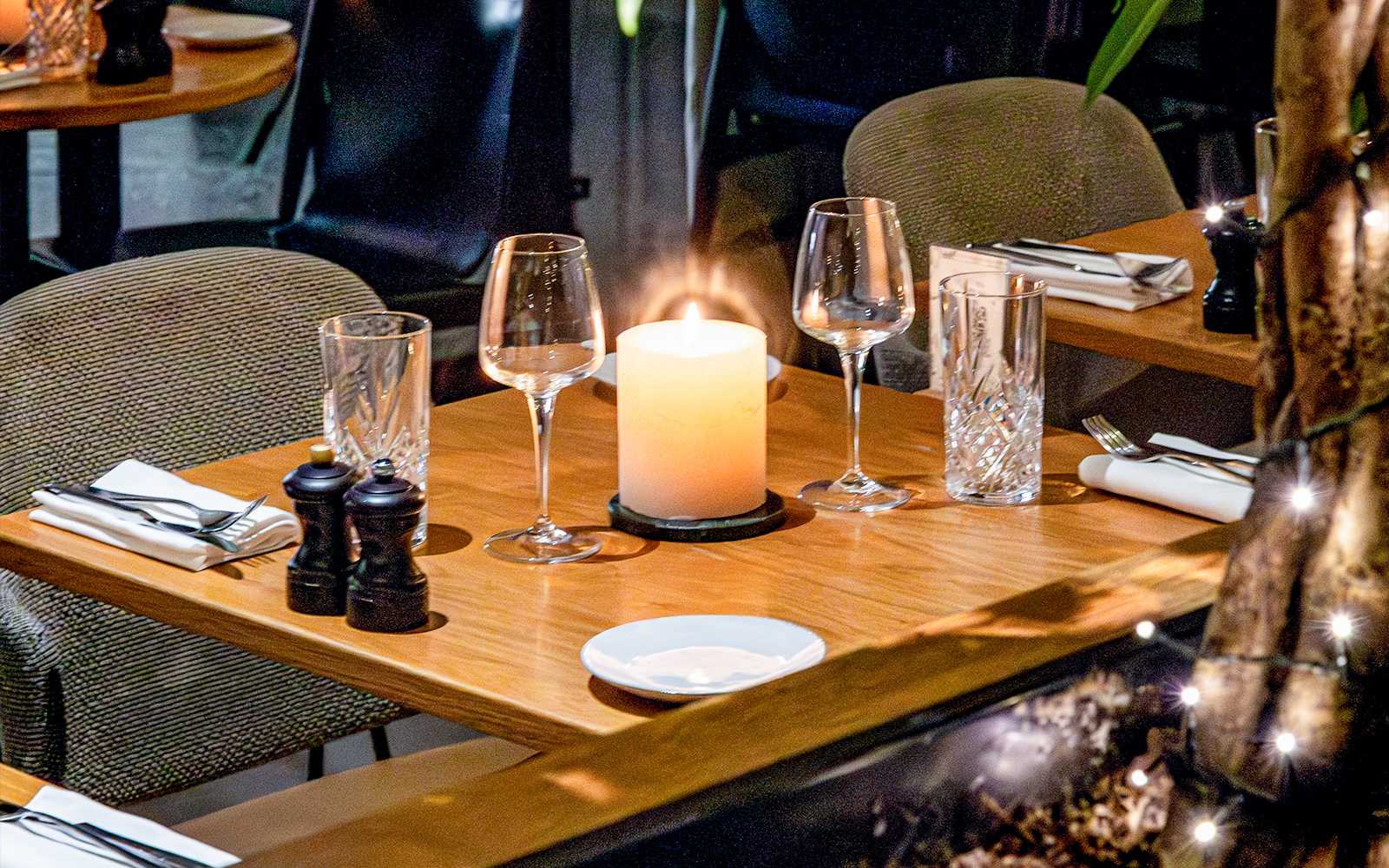 Dining table set with glassware and candle at Flora Danica, Champs Elysées, Paris.
