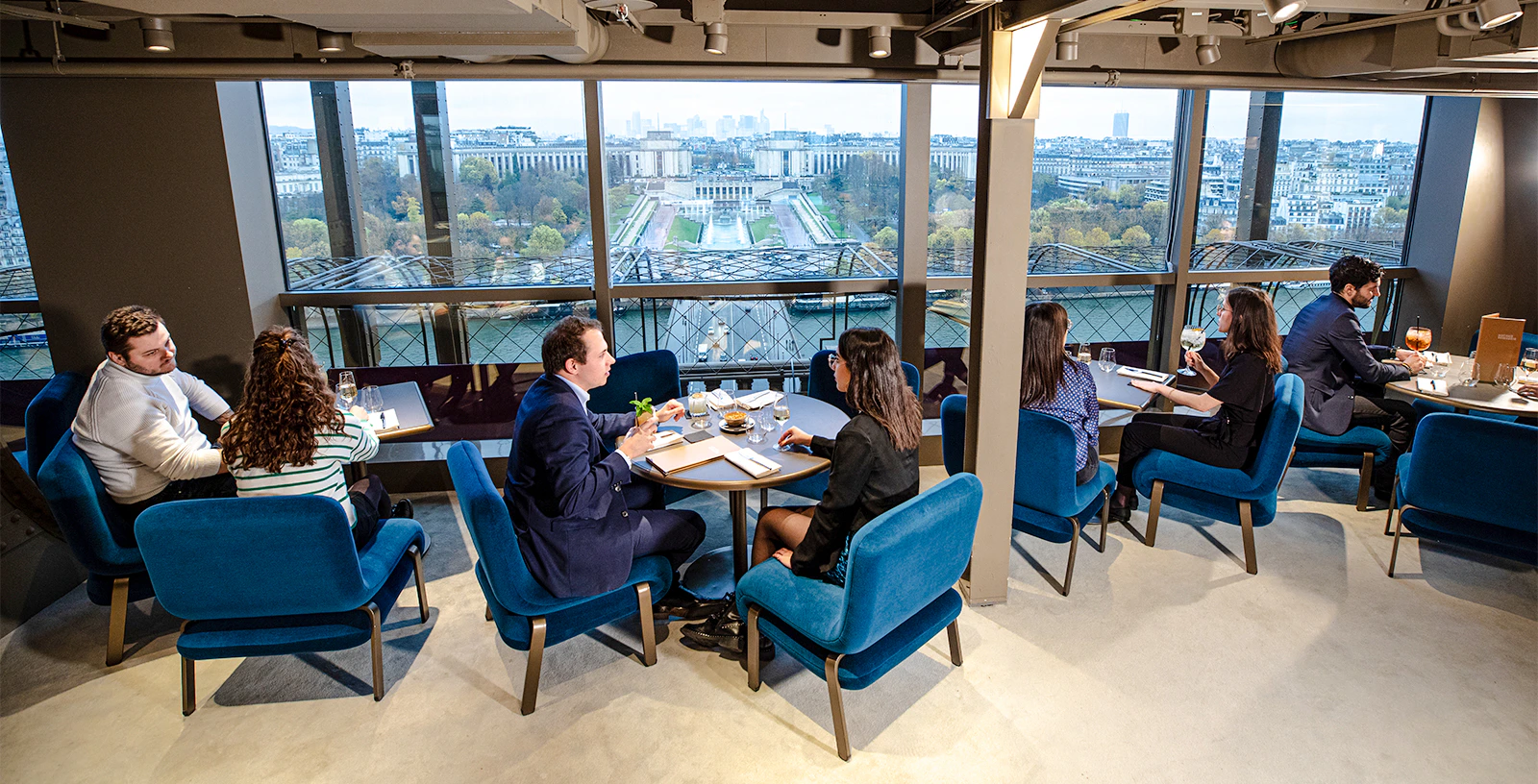 Couple dining at Madame Brasserie with Eiffel Tower view in Paris.