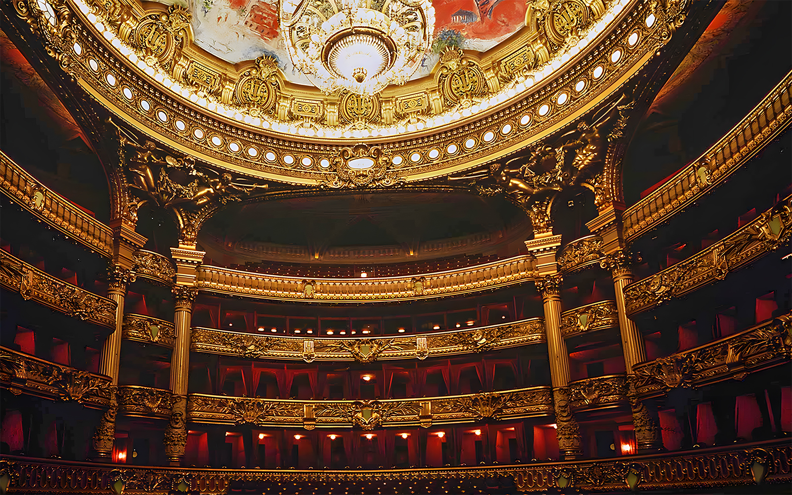 Palais Garnier interior with ornate chandeliers and grand staircase, Paris, France.