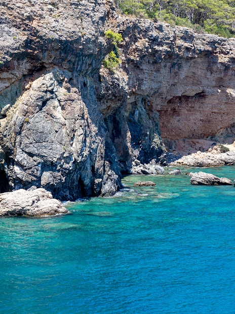 Rocky coastline and clear blue waters near Phaselis on a boat trip from Antalya.