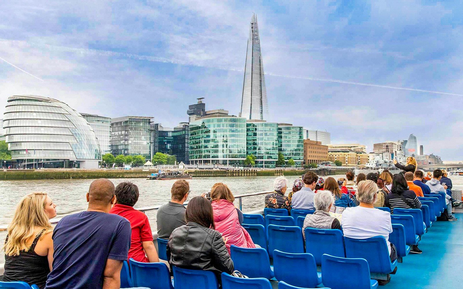 Tourists enjoying a Thames River Sightseeing Cruise from Westminster, offering unique views of London's iconic landmarks