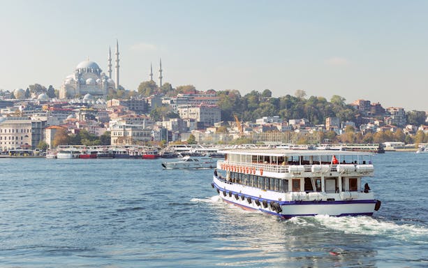 Blue Mosque in Istanbul with tourists on a Bosphorus sightseeing cruise.
