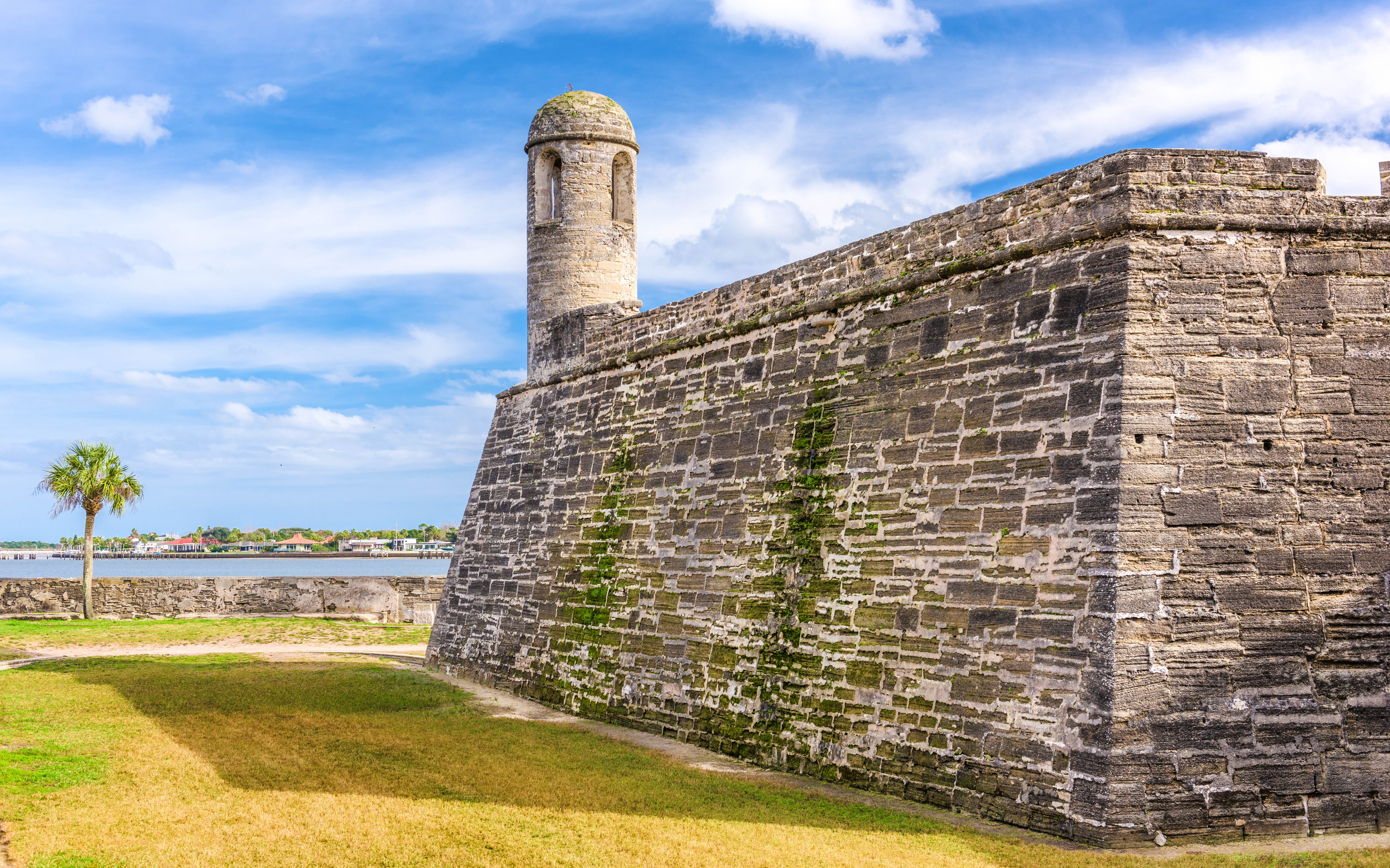 Castillo de San Marcos stone walls and watchtower, St. Augustine, Florida, with blue sky.
