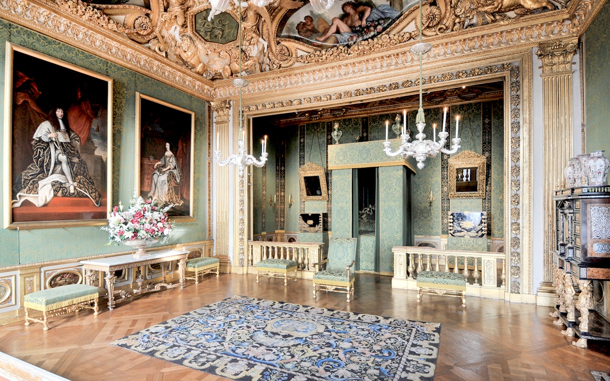 Vaux-le-Vicomte Castle interior with ornate decor and paintings on a day trip tour.