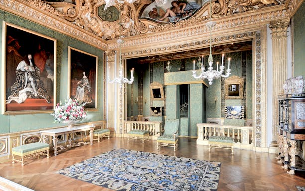 Vaux-le-Vicomte Castle interior with ornate decor and paintings on a day trip tour.