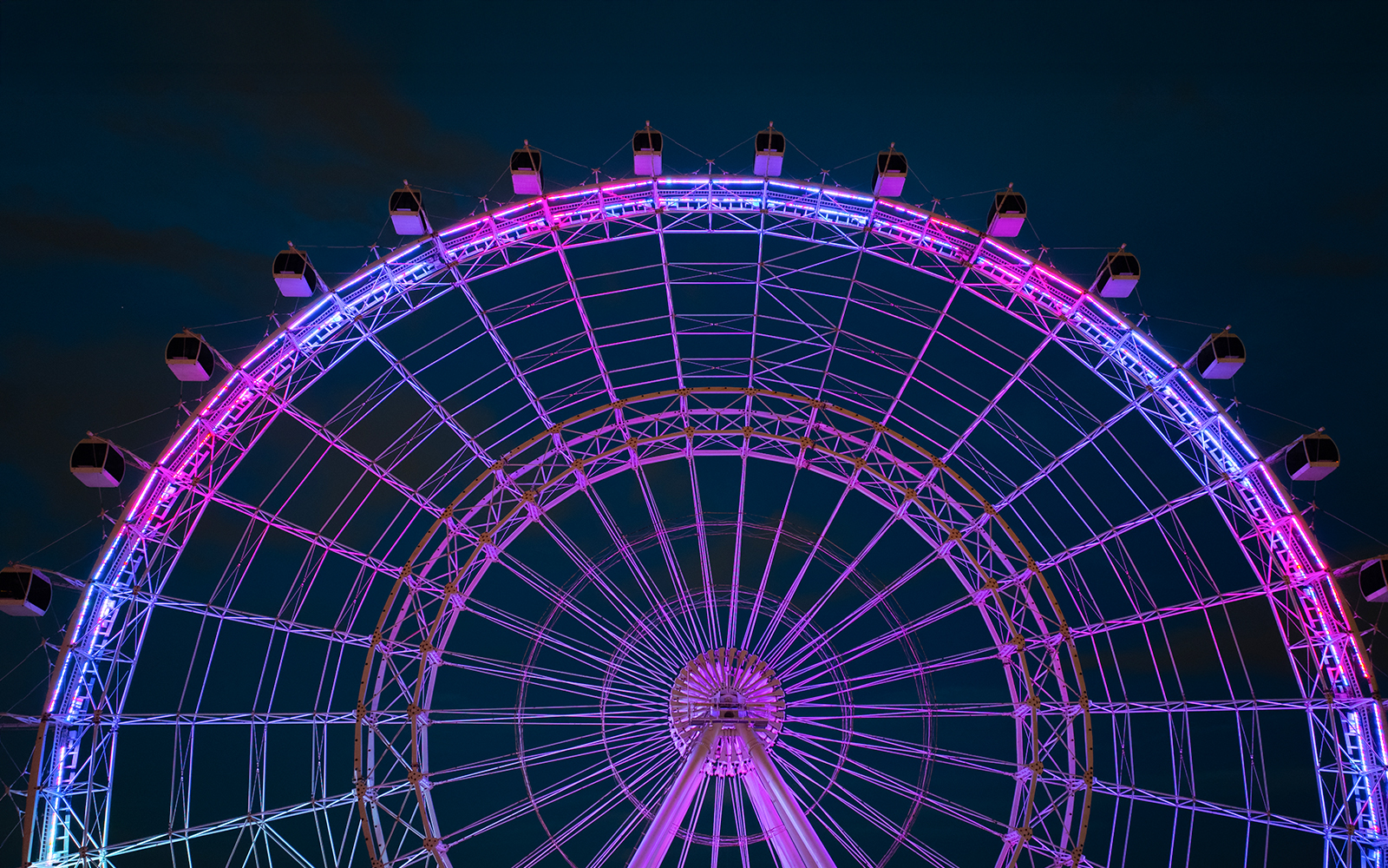 Ferris wheel illuminated at night, ICON Park, Orlando.