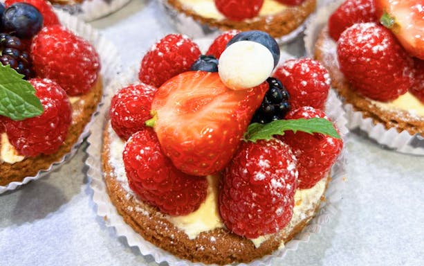 French berry tart with raspberries and strawberries, part of a Paris gourmet food tour.