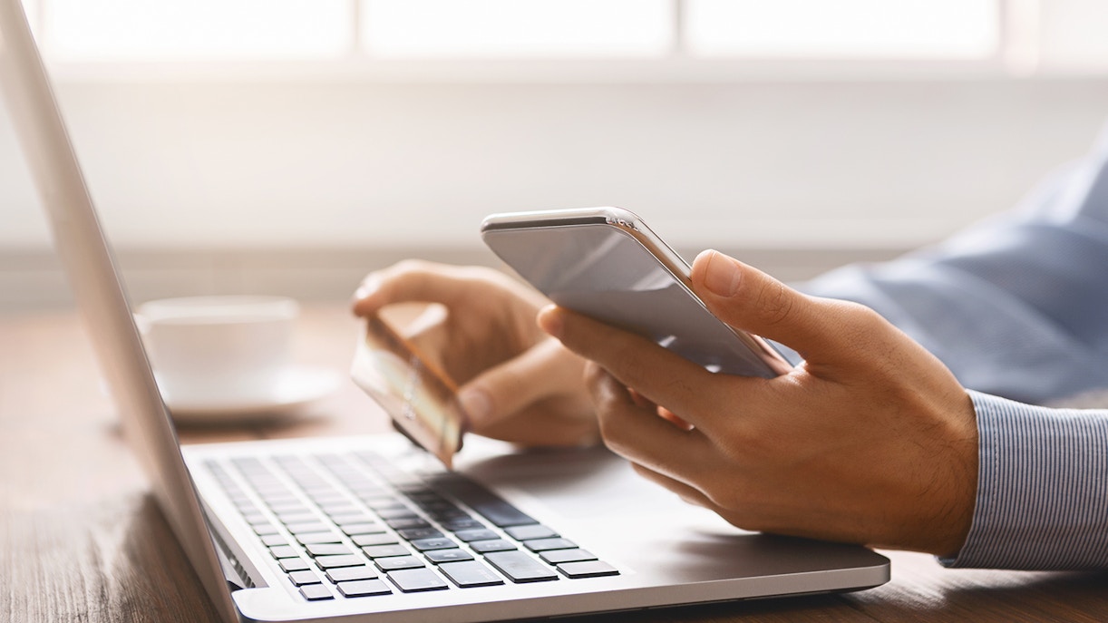 Tourist using a smartphone for online booking of Paris Eiffel Tower tickets.