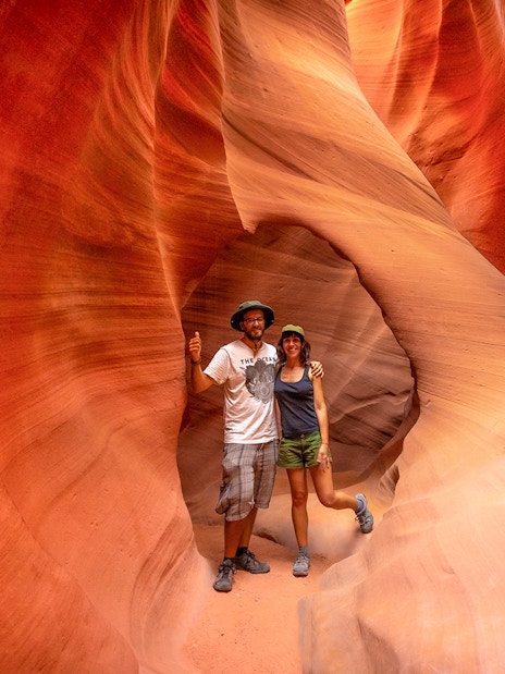 Visitors exploring the narrow sandstone walls of Antelope Valley Canyon on the Ligai Si Anii Tour.