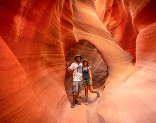 Visitors exploring the narrow sandstone walls of Antelope Valley Canyon on the Ligai Si Anii Tour.