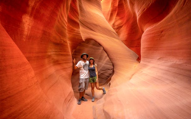 Visitors exploring the narrow sandstone walls of Antelope Valley Canyon on the Ligai Si Anii Tour.
