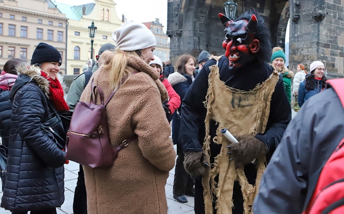 Tour guide in costume engaging tourists during Ghosts and Legends of Prague tour.