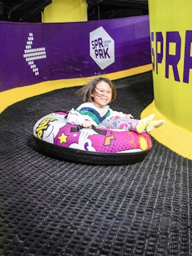 Child tubing down a slide at Super Park Malaysia.