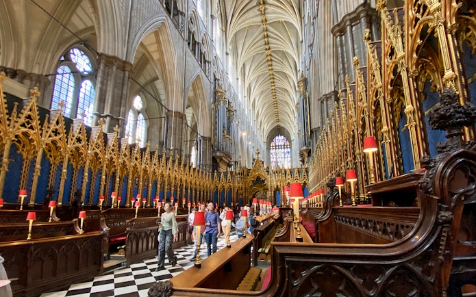 Tourists walking inside Westminster Abbey's Anglican Church, London.