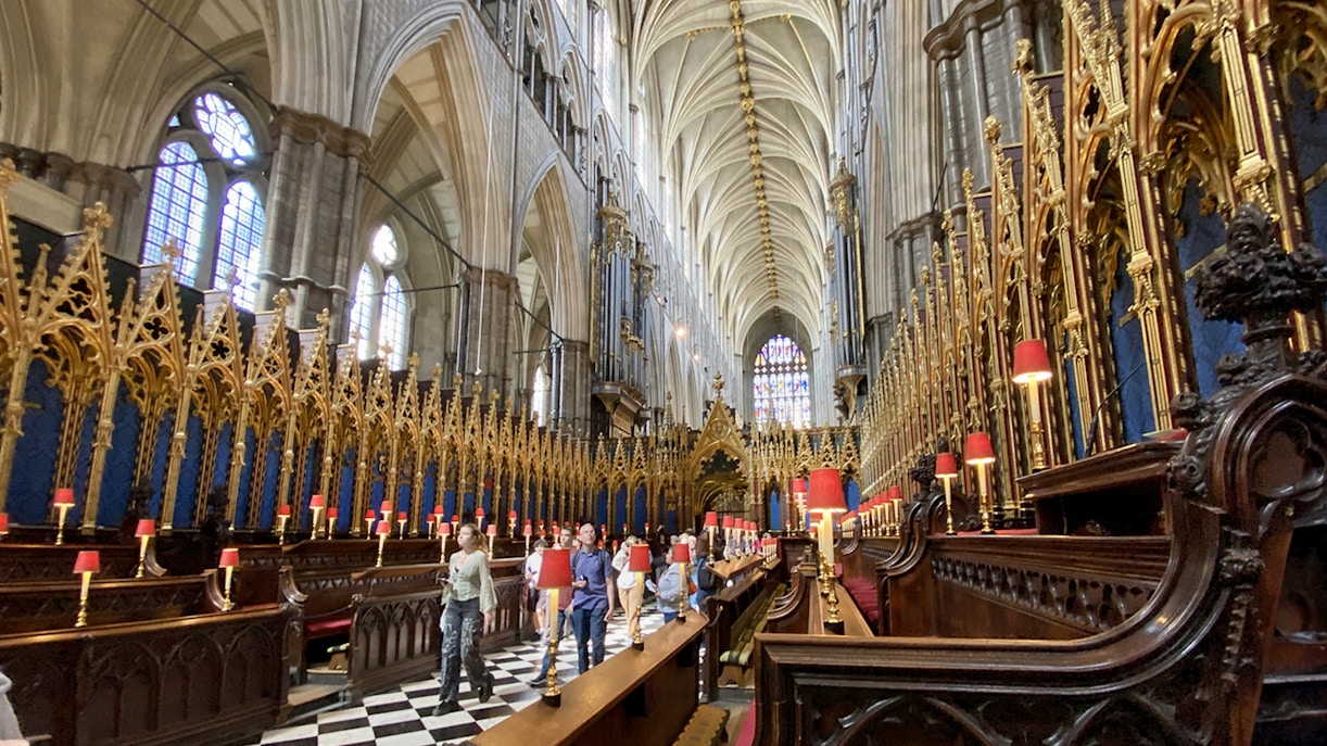 Tourists walking inside Westminster Abbey's Anglican Church, London.