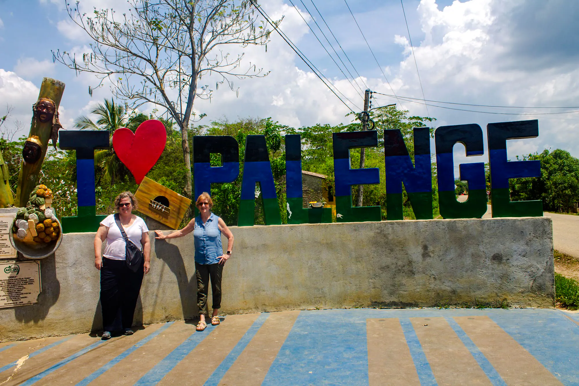 Tourists at San Basilio de Palenque sign, Cartagena day tour.