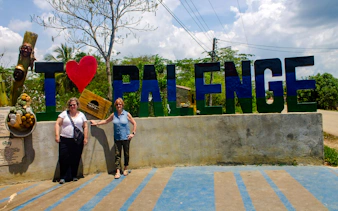 Tourists at San Basilio de Palenque sign, Cartagena day tour.