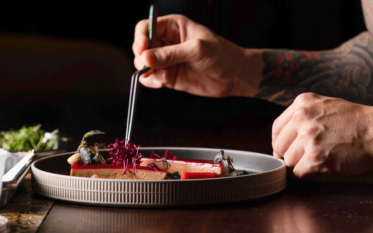 Dining experience at CÉ LA VI Dubai with gourmet dish preparation.