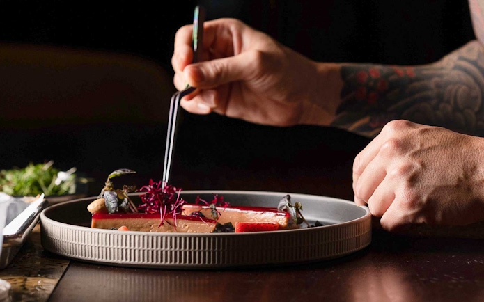 Dining experience at CÉ LA VI Dubai with gourmet dish preparation.