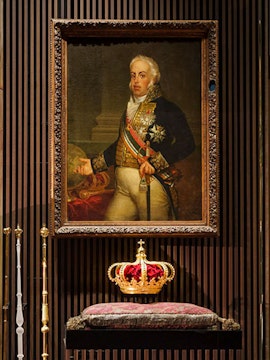 Portrait of a historical figure with a crown on display at the Royal Treasure Museum.