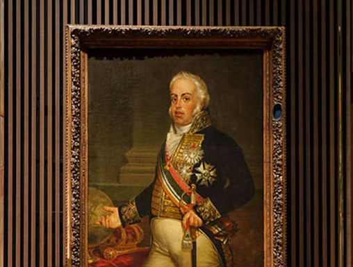 Portrait of a historical figure with a crown on display at the Royal Treasure Museum.