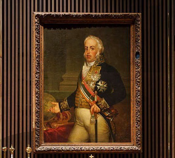 Portrait of a historical figure with a crown on display at the Royal Treasure Museum.