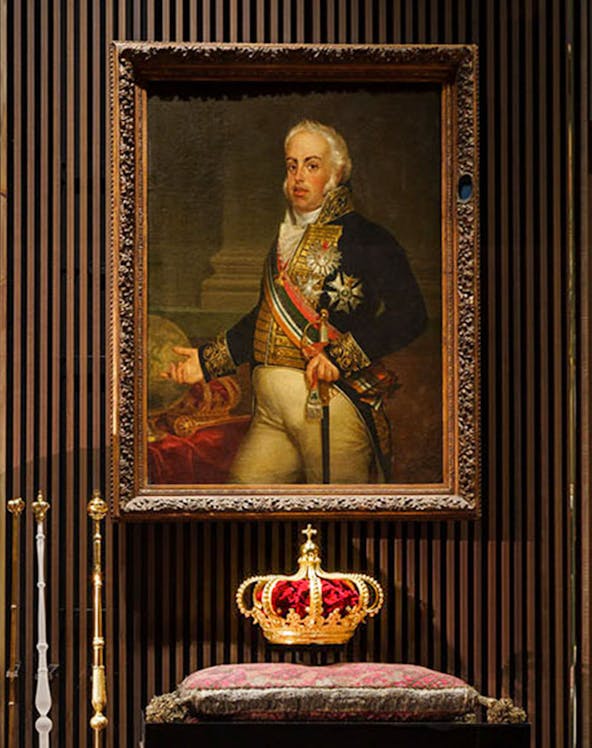 Portrait of a historical figure with a crown on display at the Royal Treasure Museum.