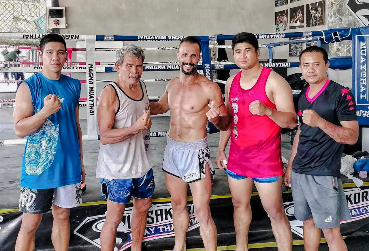 Muay Thai instructors and students in a boxing ring during a beginner class in Pattaya.