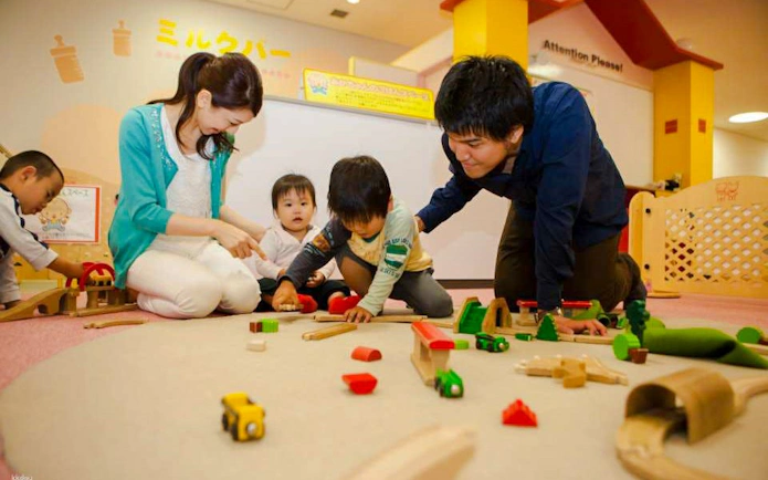 Children playing with toy trains at Kids Plaza Osaka.