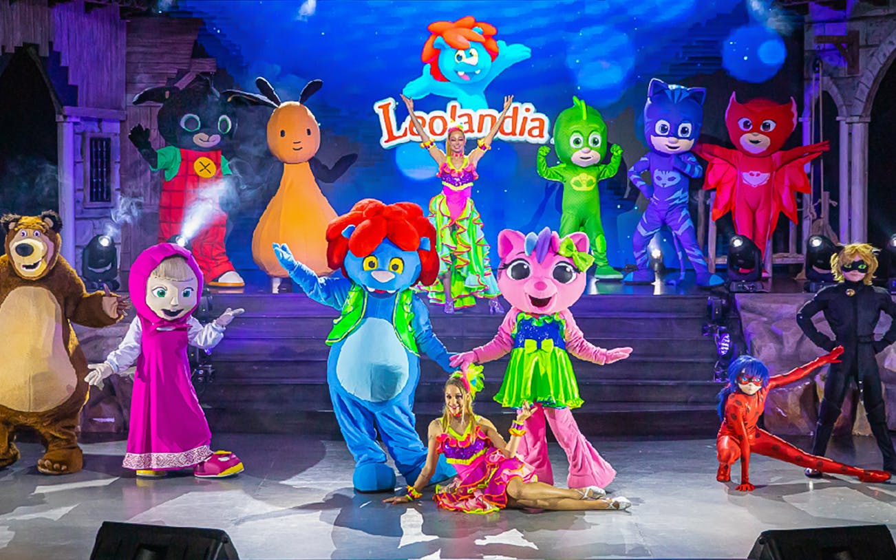 Characters performing on stage at Leolandia theme park.