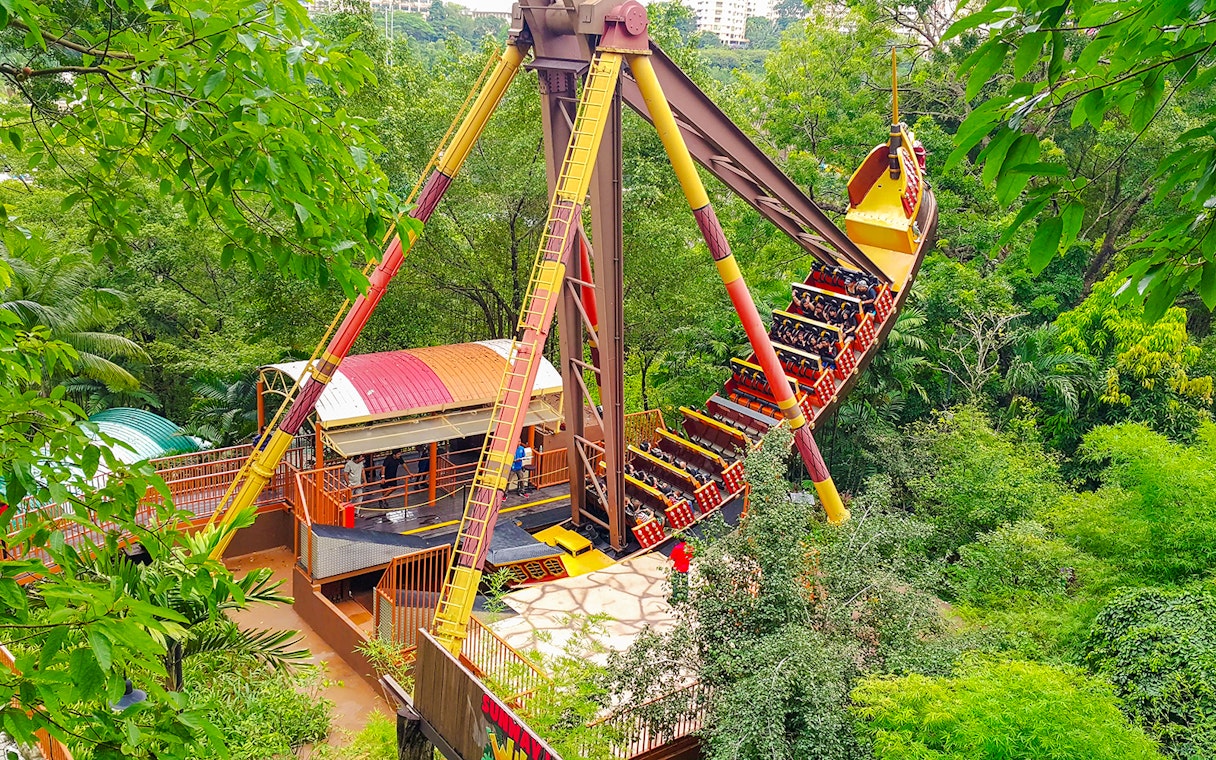 Sunway Lagoon amusement park ride surrounded by lush greenery.