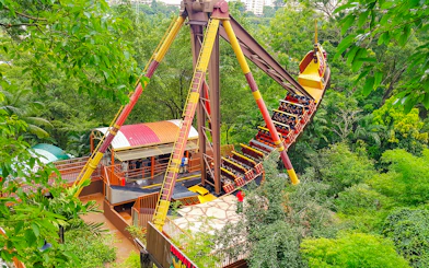 Sunway Lagoon amusement park ride surrounded by lush greenery.