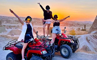 ATV riders enjoying a sunset tour in Cappadocia with scenic views and rocky landscapes.