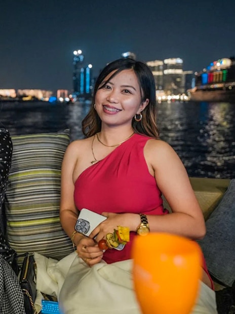 Ladies enjoying BBQ on a Dubai Marina yacht party at night.