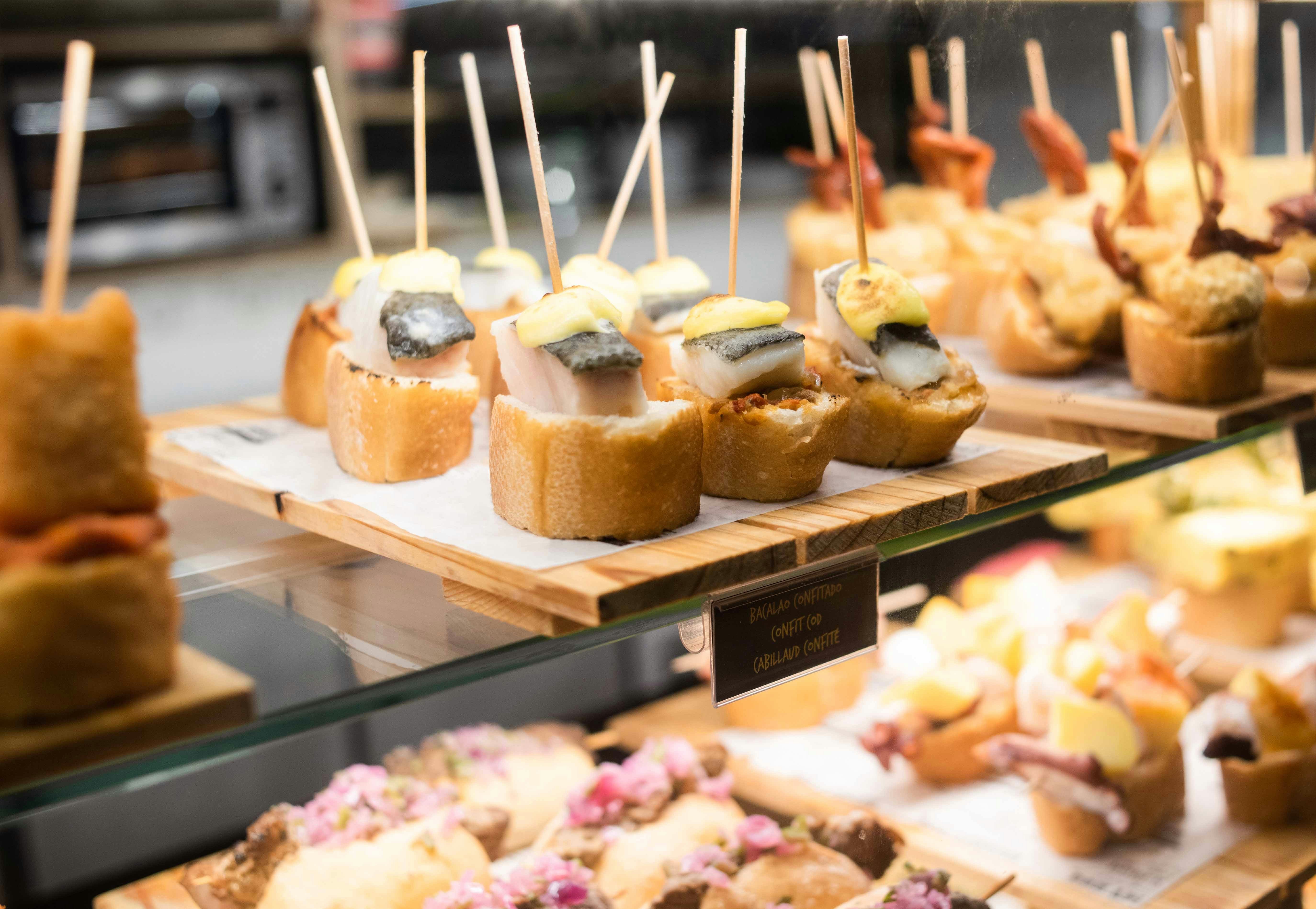 Spanish tapas with fish and sauce on bread in a Madrid bar.