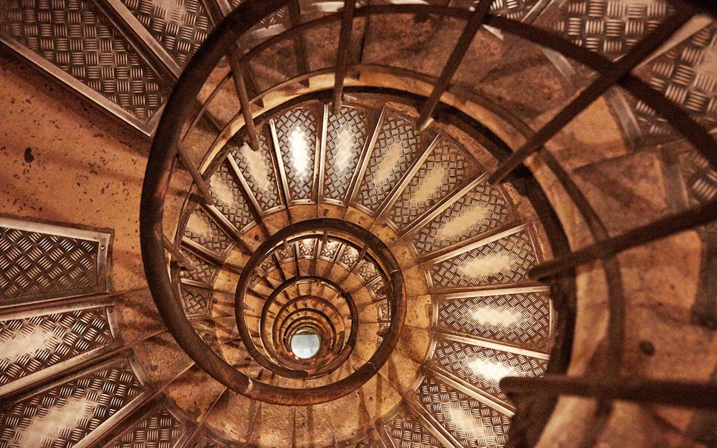 Spiral staircase inside Arc de Triomphe, Paris, viewed from above.