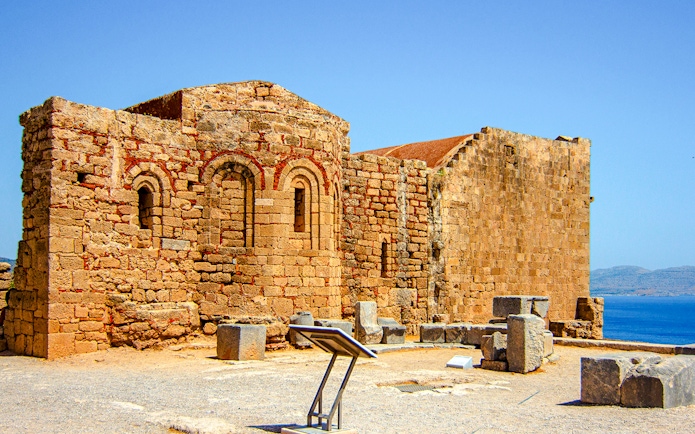 Ruins of Byzantine church of St. John at Acropolis of Lindos with sea view.