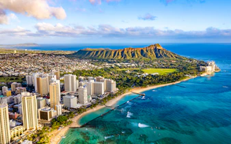 Waikiki skyline with Queen Kapiolani Park, Kuhio Beach, and Diamond Head in the background.