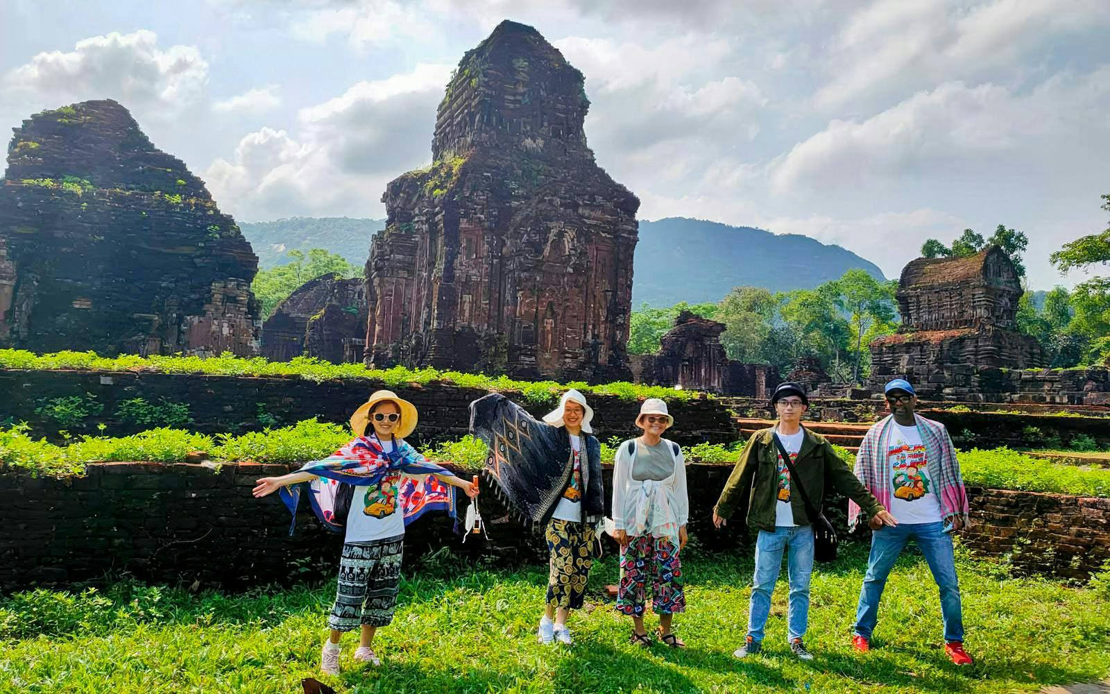 Tourists exploring ancient ruins at My Son Sanctuary, Vietnam.