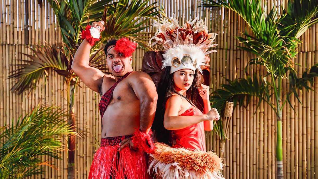 Performers in traditional attire posing before a cultural show at Mauka Warriors Luau, Hawaii.