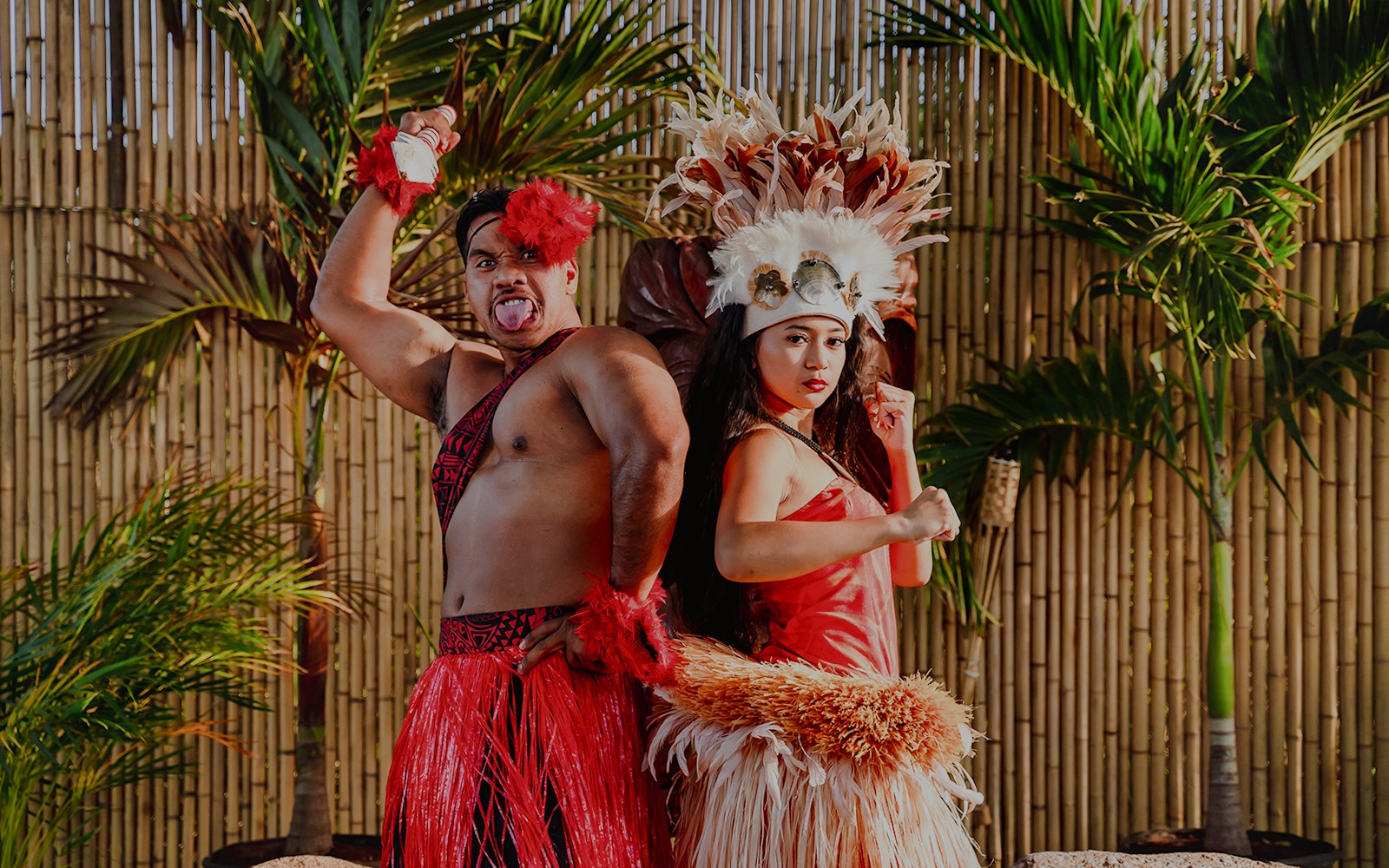 Performers in traditional attire posing before a cultural show at Mauka Warriors Luau, Hawaii.