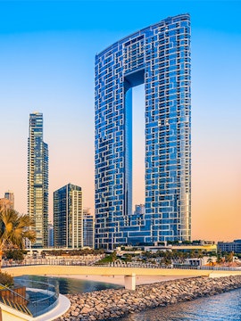 Jumeirah Beach Dubai skyline with modern skyscrapers at sunset.